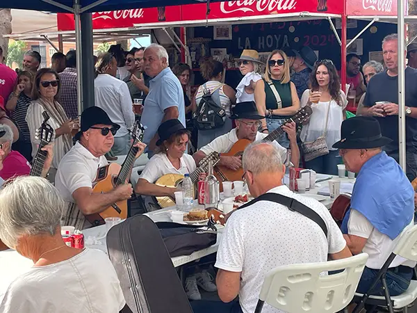 A band plays traditional Spanish music while drinking and eating tapas