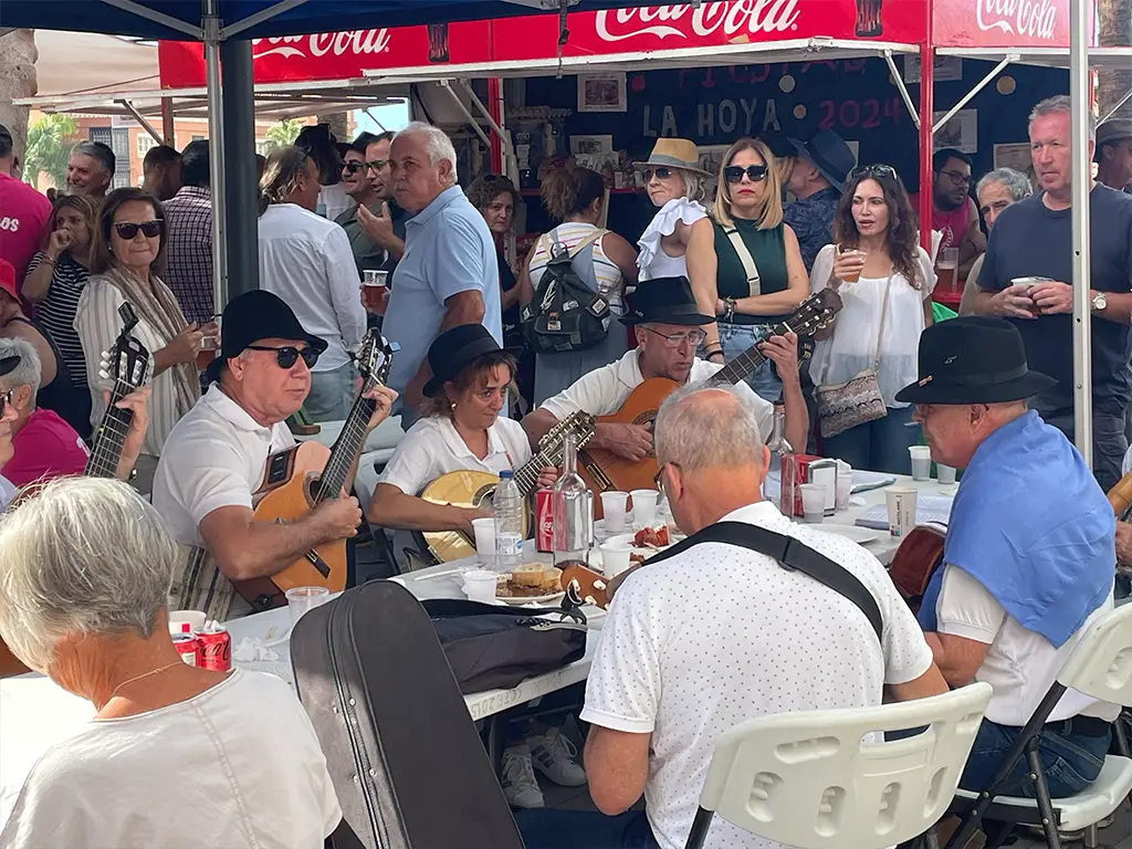 A band plays traditional Spanish music while drinking and eating tapas